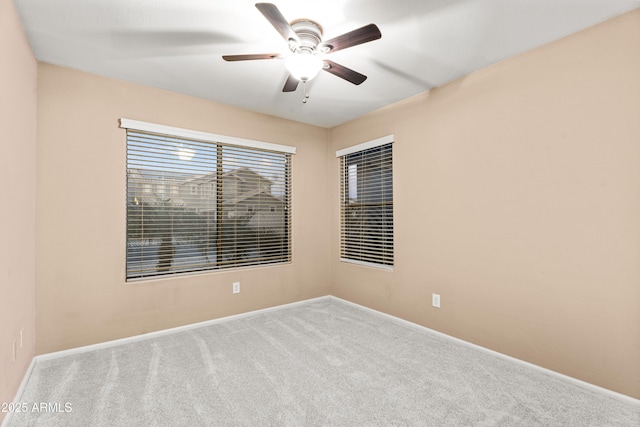 empty room featuring light carpet and ceiling fan