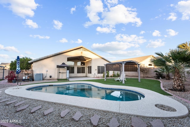 view of pool featuring a yard, central AC, a gazebo, a pergola, and a patio