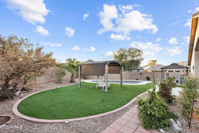 view of yard featuring a gazebo, a fenced in pool, and central air condition unit