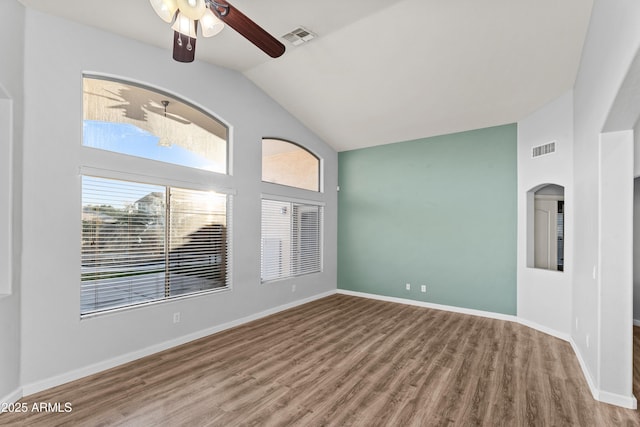 spare room with ceiling fan, lofted ceiling, and hardwood / wood-style floors