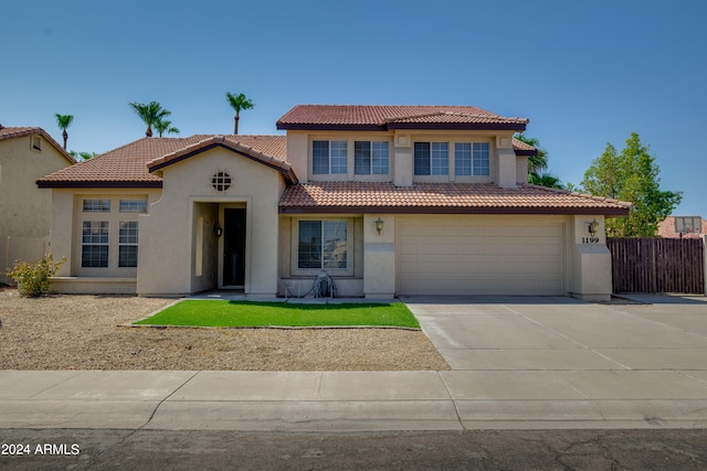 mediterranean / spanish-style home with a garage