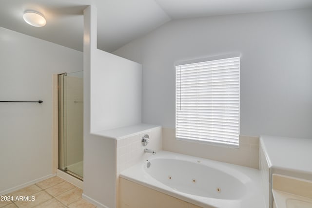 bathroom featuring lofted ceiling, tile patterned floors, and independent shower and bath