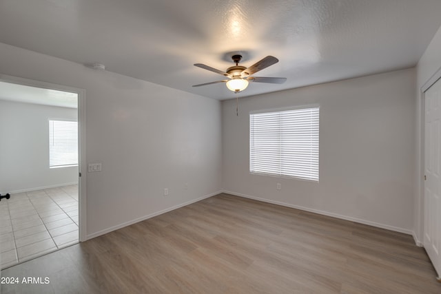 empty room featuring ceiling fan and light hardwood / wood-style floors