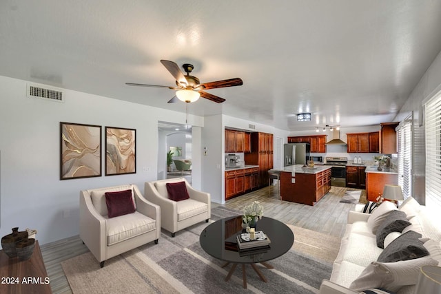 living room featuring ceiling fan and light wood-type flooring