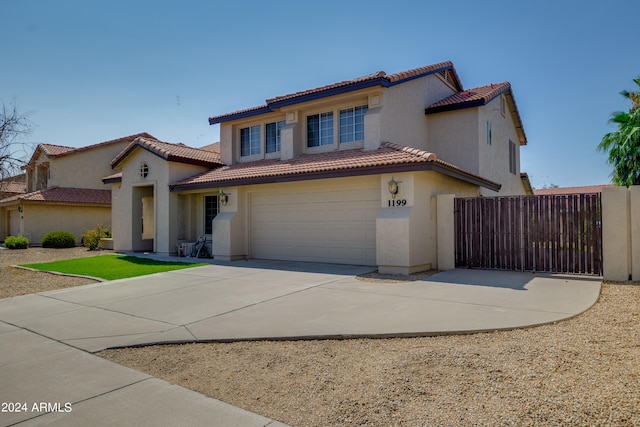 mediterranean / spanish-style home with a garage