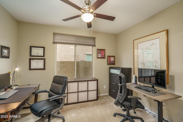 office space with ceiling fan, baseboards, and carpet