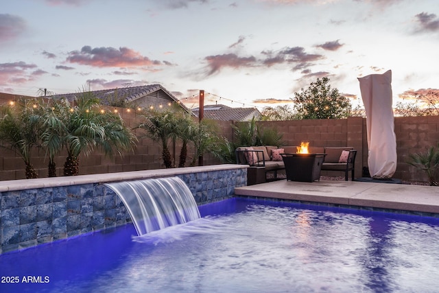 view of pool with a fenced in pool, a patio, a fire pit, and a fenced backyard