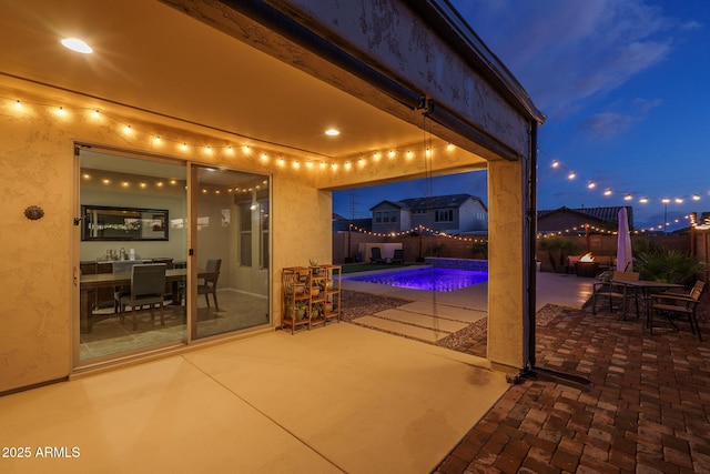 view of patio / terrace featuring outdoor dining space, a fenced in pool, and a fenced backyard