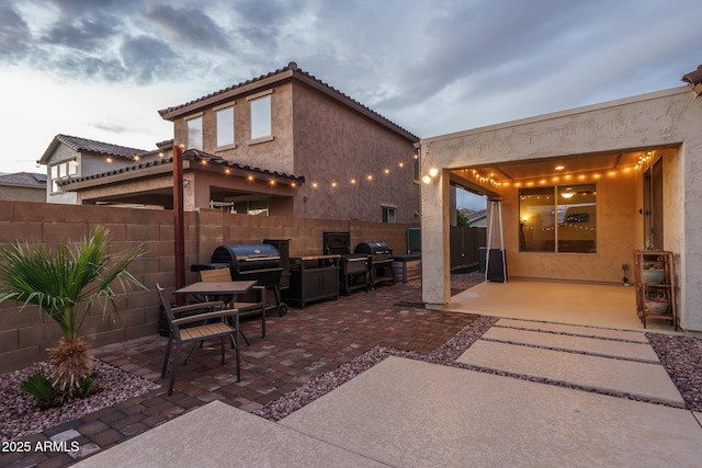 view of patio / terrace with fence and a grill