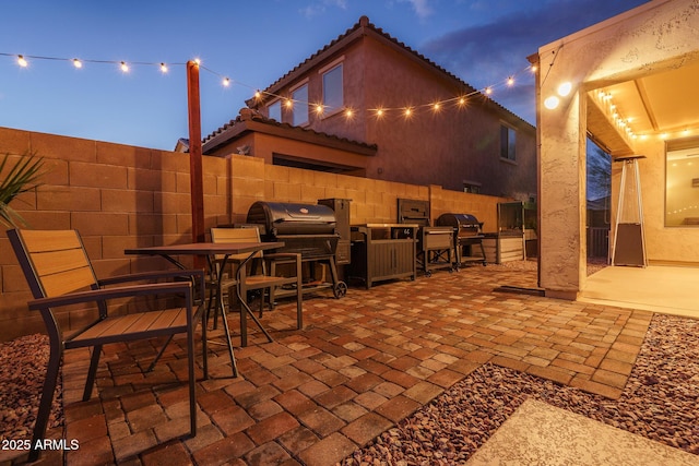 view of patio / terrace with grilling area, exterior kitchen, and fence