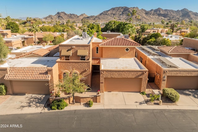 view of front of home featuring a mountain view and a garage