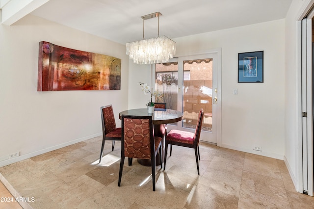 dining area featuring an inviting chandelier