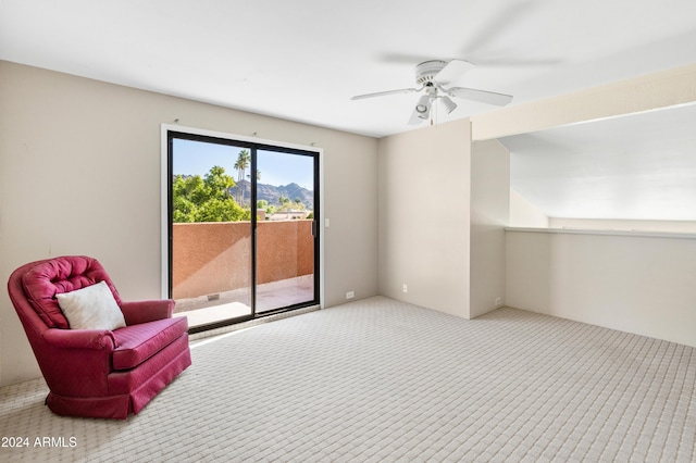 living area with ceiling fan and light carpet