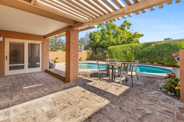 view of patio featuring a fenced in pool and a pergola