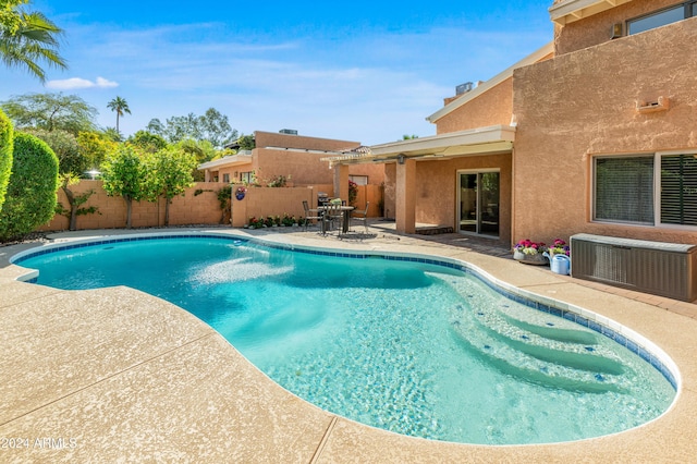 view of swimming pool with a patio area