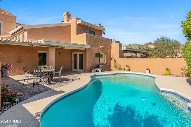 view of pool with a patio and central AC