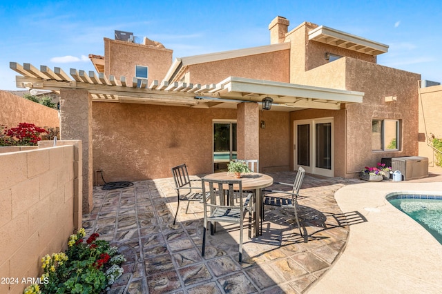 rear view of house featuring a fenced in pool, a pergola, a patio, and central AC unit