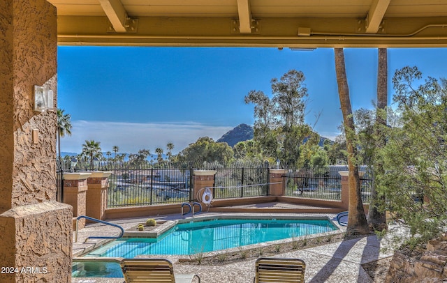 view of pool featuring a mountain view and a patio