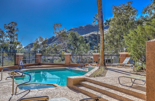 view of pool featuring a mountain view and a patio