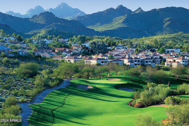 view of property's community featuring a mountain view and a yard