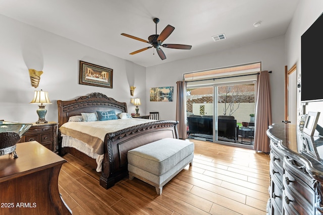 bedroom with access to exterior, light wood-style flooring, visible vents, and ceiling fan