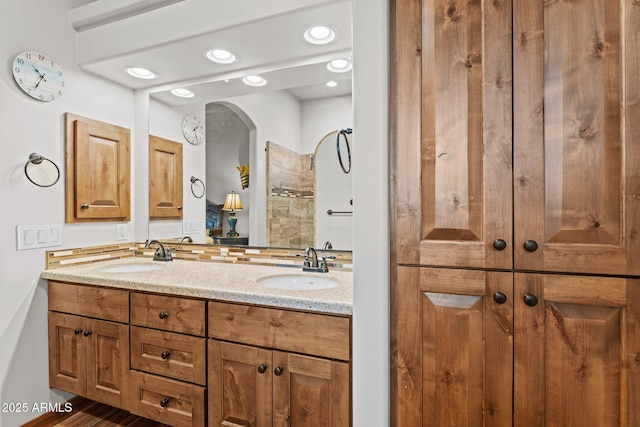 full bathroom featuring a sink, recessed lighting, and double vanity