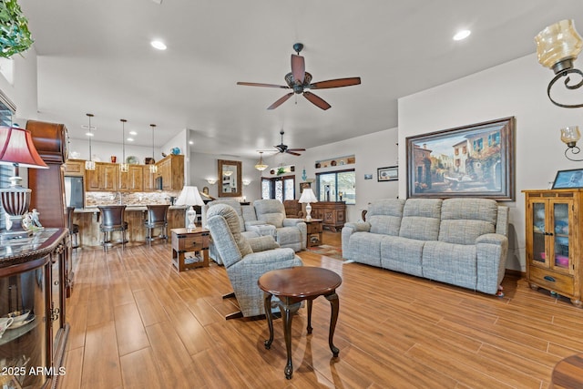 living area with recessed lighting, light wood-style floors, and ceiling fan