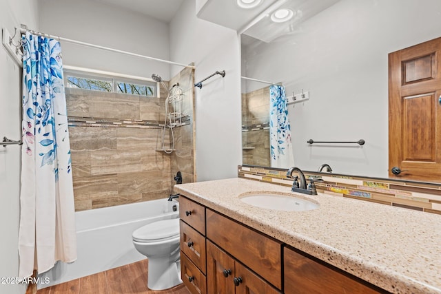 bathroom with toilet, vanity, and shower / bath combo