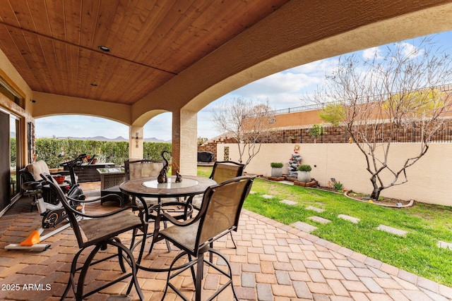 view of patio with outdoor dining area and a fenced backyard