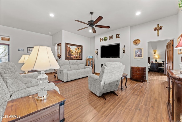 living room with recessed lighting, light wood-type flooring, and ceiling fan