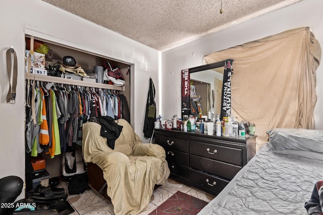 bedroom with a textured ceiling and a closet
