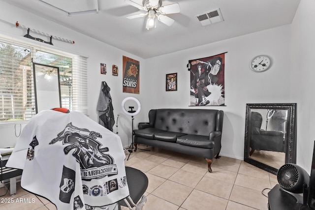living room with light tile patterned floors and a ceiling fan