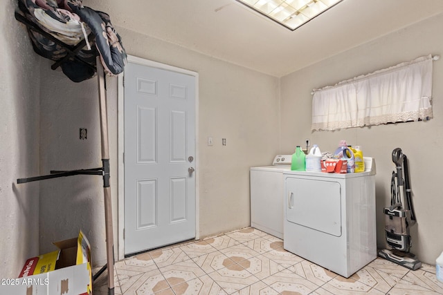 laundry area with washing machine and dryer and light tile patterned flooring
