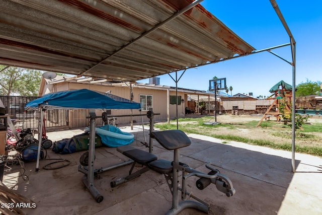 view of patio with a playground and a fenced backyard