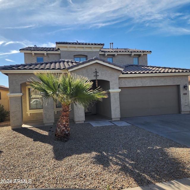 mediterranean / spanish-style home with a garage