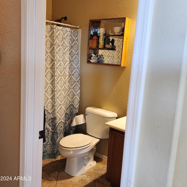 bathroom with tile patterned floors, vanity, and toilet