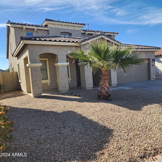 mediterranean / spanish-style house featuring a garage