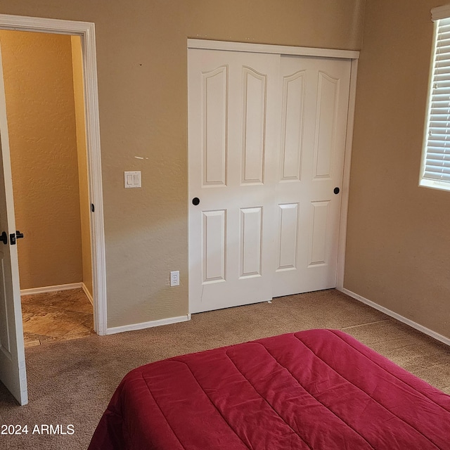 unfurnished bedroom featuring a closet and carpet floors