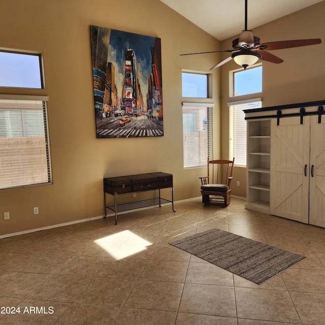 entryway with a barn door, light tile patterned floors, and a wealth of natural light