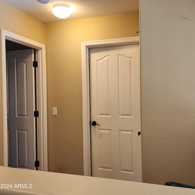 corridor with a textured ceiling