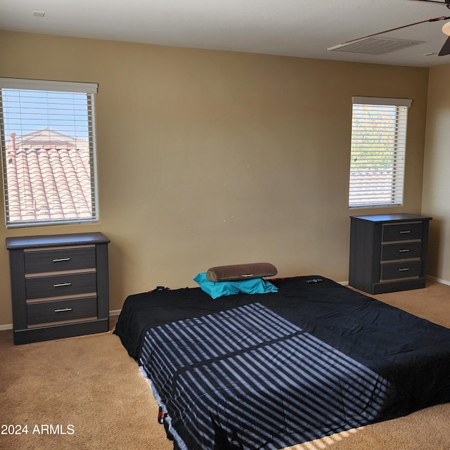 carpeted bedroom with ceiling fan