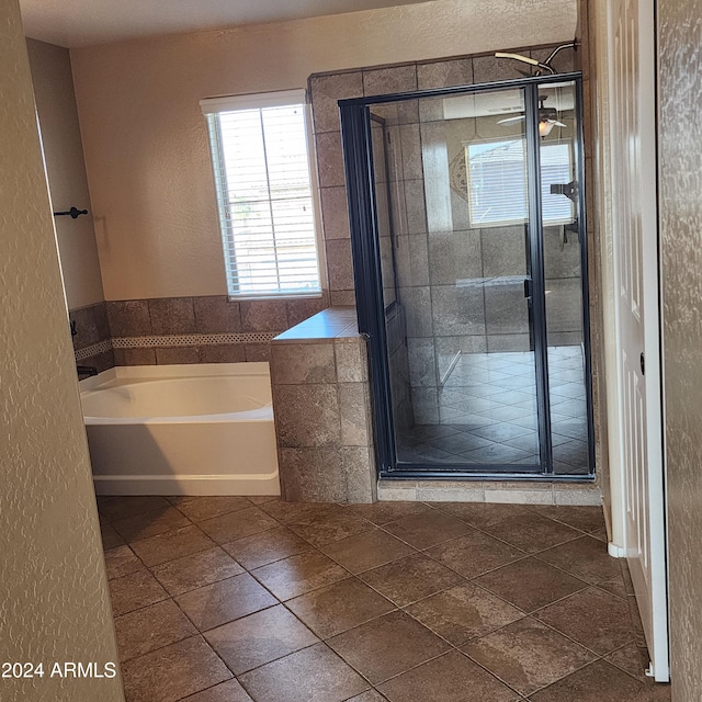 bathroom featuring ceiling fan, tile patterned flooring, and a bath