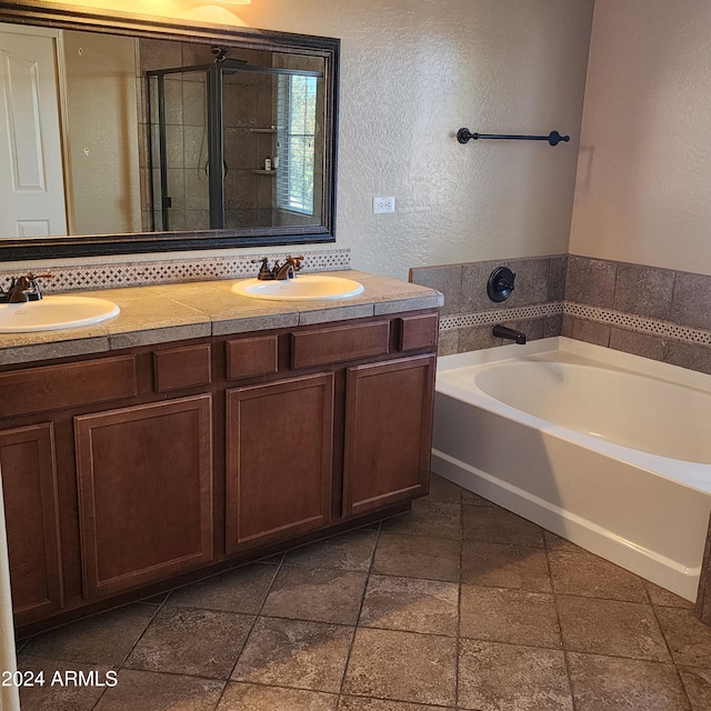 bathroom with vanity and shower with separate bathtub