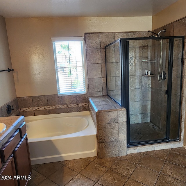 bathroom featuring shower with separate bathtub and vanity