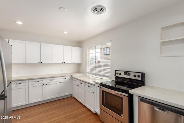 kitchen with visible vents, recessed lighting, stainless steel appliances, white cabinets, and light wood-type flooring