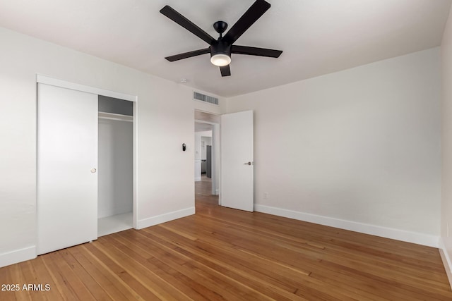 unfurnished bedroom with a ceiling fan, baseboards, visible vents, a closet, and light wood-type flooring