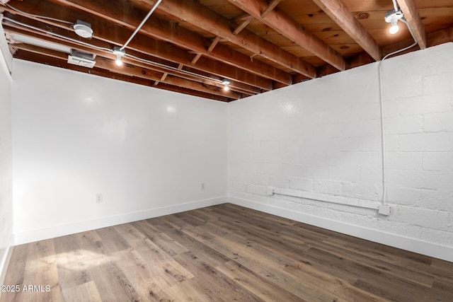 finished basement with baseboards and wood finished floors