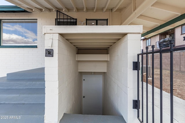 doorway to property with concrete block siding