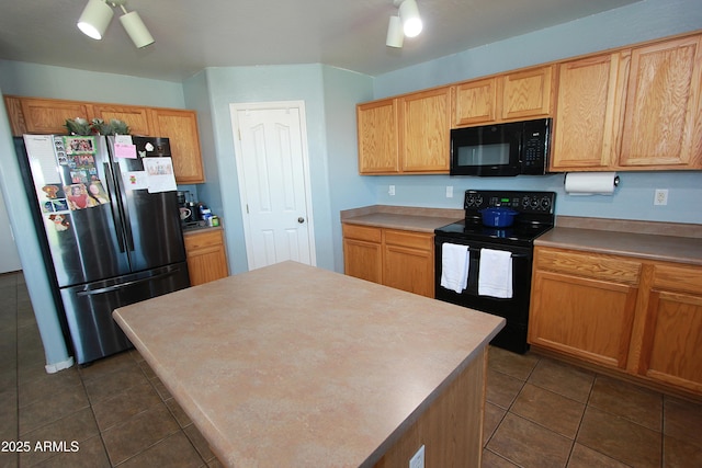 2434 E San Manuel Rd, San Tan Valley, AZ 85143 - kitchen featuring a center island, light countertops, dark tile patterned flooring, and black appliances