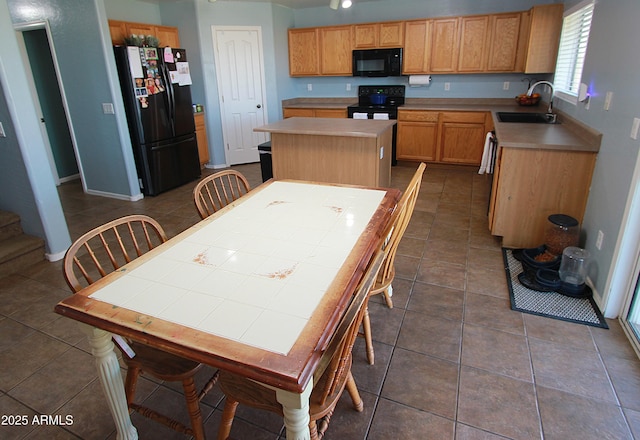 2434 E San Manuel Rd, San Tan Valley, AZ 85143 - kitchen featuring a center island, a sink, dark tile patterned flooring, baseboards, and black appliances